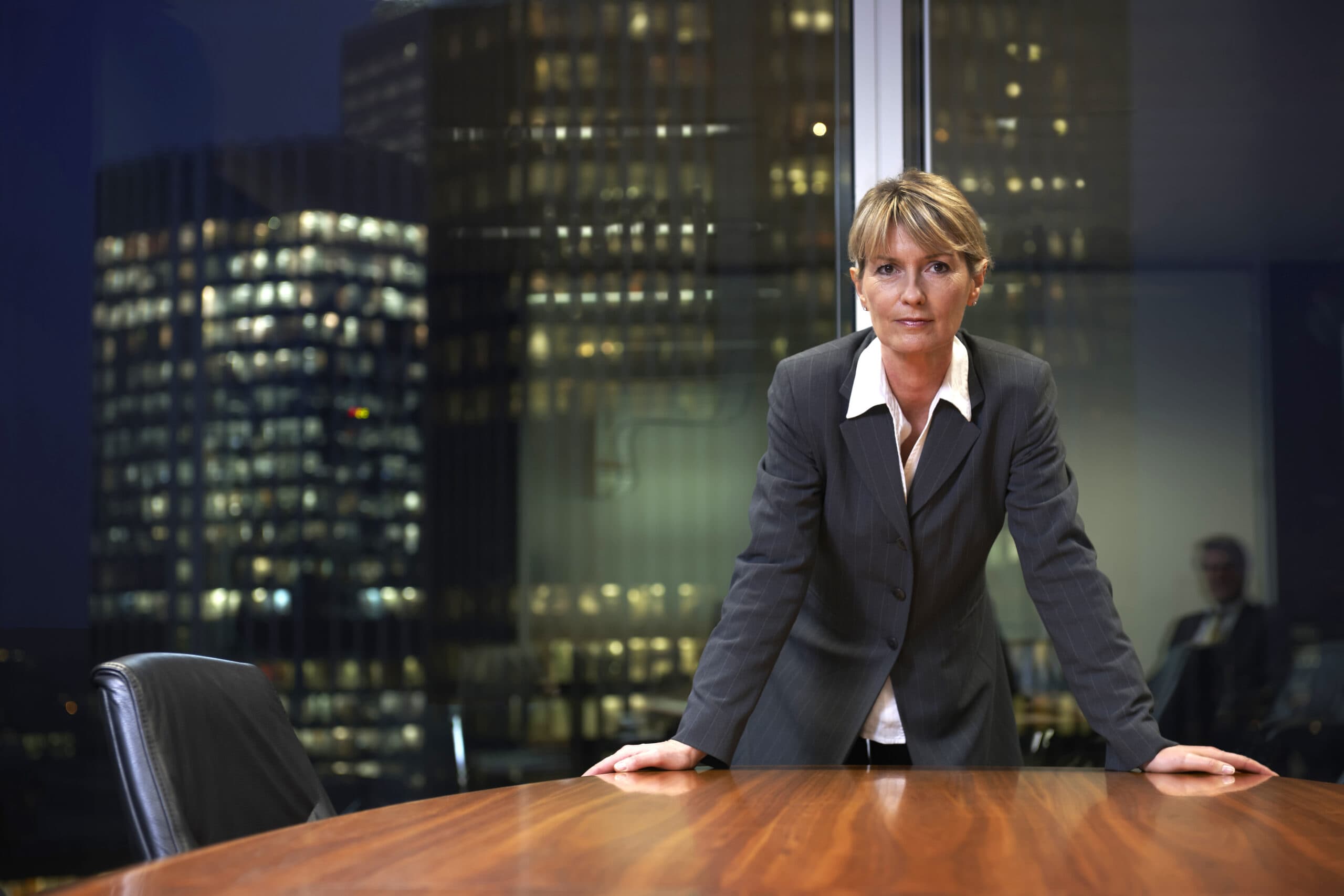 Executive at a desk with city skyline in background